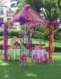 an outdoor birthday party with purple and orange decorations