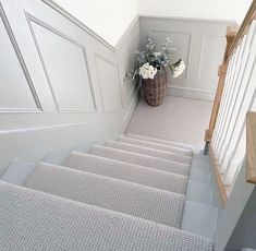 there is a basket with flowers on the top of some stairs next to a set of stairs