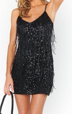 The Sparks Fly Mini Dress in Black Beaded Fringe is the perfect holiday dress with silver sequins and beaded straps. Pair with our SJP Collection Defy Heels for the perfect look! Black Sparkly Fringe Dress, Nye Look, Black Sparkly Dress, Tie Dye Tops, Maternity Bridesmaid Dresses, Sparks Fly, Nye Outfits, Hugging Silhouette, Mini Dress Black