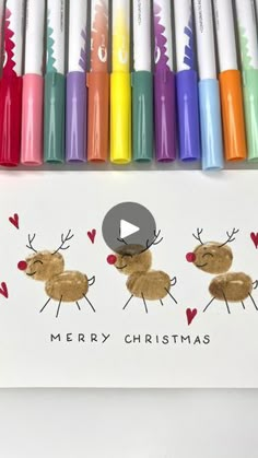 a christmas card with markers and crayons on it, depicting reindeers in different colors