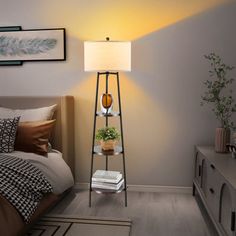 a bed room with a neatly made bed and a lamp