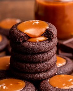 chocolate cookies with peanut butter on top and caramel sauce in the middle, sitting next to each other