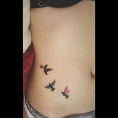 a woman's stomach with three birds on it and the bottom part of her belly