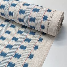 a blue and white fabric with red stripes