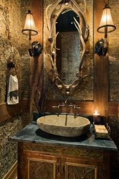 a bathroom sink sitting under a mirror next to a wall mounted faucet with lights on it