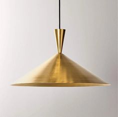 a gold colored pendant light hanging from a ceiling