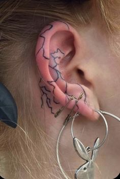 a person with ear piercings and gloves on