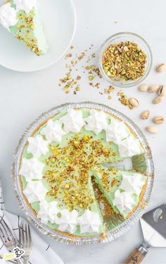 there is a pie on the table with some nuts and other food items around it