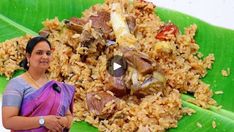 a woman standing next to a pile of food on top of a green banana leaf