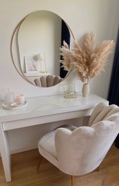 a white desk with a mirror and chair