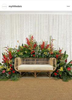 an arrangement of flowers and greenery on a couch