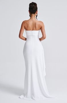 the back of a woman wearing a white gown