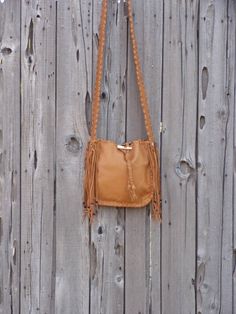 This leather tote is a great size for your every day needs. This bag is made of saddle tan leather and is 10 inches tall, 10 inches wide and 2.75 inches deep. We can make this bag in any of the colors of leather you see in our shop. It has an extra pocket inside and a comfortable 48 inch flat strap. Let us know how long you like your strap. We can make this bag in a variety of colors of soft tanned cowhide ( see the last photo ). Just leave a note at check out or contact us... This item is MADE Brown Fringe Bag For Everyday Use, Camel Crossbody Shoulder Bag With Leather Handles, Leather Satchel Bag With Fringe, Natural Leather Crossbody Bucket Bag, Brown Bag With Handle Drop For Fall, Brown Bags With Handle Drop For Fall, Fall Camel Shoulder Bag With Adjustable Strap, Camel Satchel Shoulder Bag For Fall, Camel Shoulder Bag For Everyday Fall Use