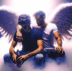 two men sitting on the ground with their arms around each other and wings above them