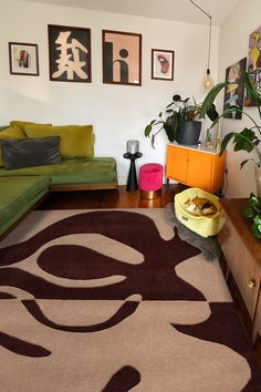 a living room filled with furniture and lots of plants on top of a wooden table