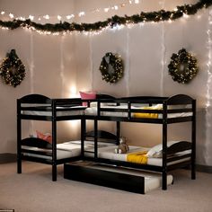 bunk beds with lights and wreaths on the wall