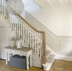 a white staircase in a house with wood flooring