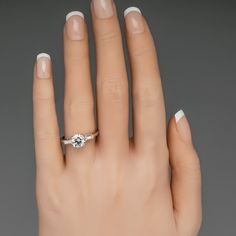 a woman's hand with a diamond ring on it