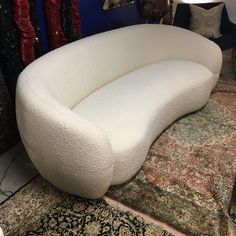 a large white couch sitting on top of a rug