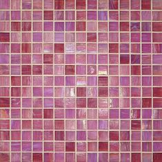 a close up view of a pink tile wall