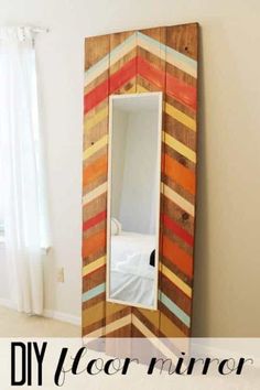 a mirror made out of strips of wood with the words diy floor mirror on it