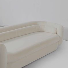 a white couch sitting on top of a hard wood floor