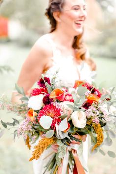 a woman holding a bouquet of flowers in her hands