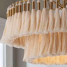 a chandelier hanging from the ceiling with long hair on it