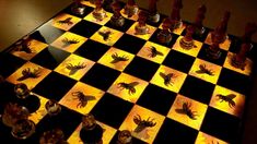 a chess board with bugs on it is lit up by the light of a candle