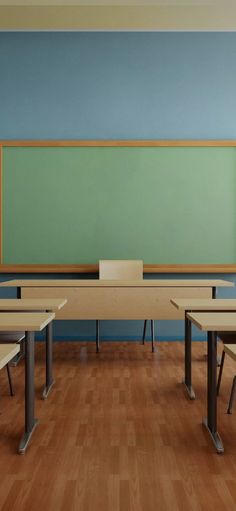 an empty classroom with two desks and a chalkboard on the wall behind it