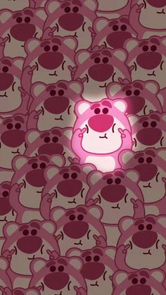 an animated pink bear surrounded by many other cartoon faces, with the light shining on its face