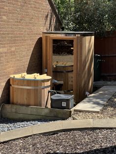 a wooden hot tub sitting next to a brick building