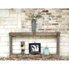 a wooden shelf with two pictures on it and a potted plant next to it