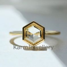 a gold ring with an octagonal cut diamond