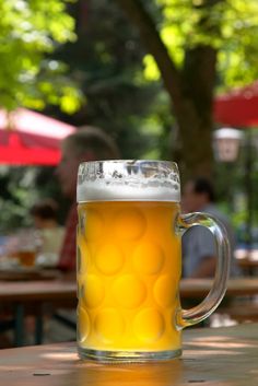 a beer mug sitting on top of a wooden table