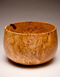 a wooden bowl sitting on top of a table