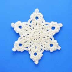 a crocheted snowflake on a blue background