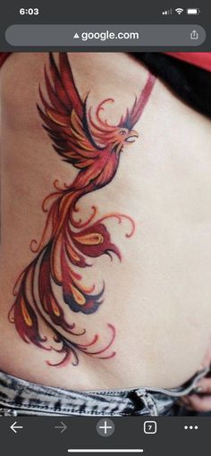 a woman's stomach with a bird tattoo on it