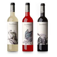 three bottles of red wine are shown in this image, one has a butterfly on it