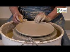 a person is working on a pottery wheel