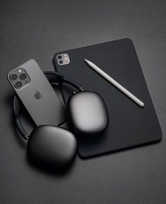 an iphone and ear buds on top of a black surface