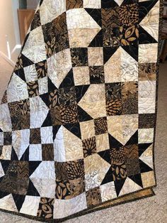 a black and white quilt on the floor