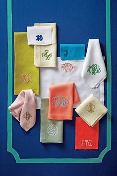 the monogrammed handkerchiefs are laid out on top of each other in different colors