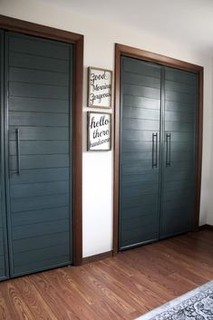 three wooden doors in a room with wood flooring and white walls, along with an area rug on the floor