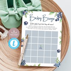 a baby buggy game on a wooden plate next to a green purse and blueberries