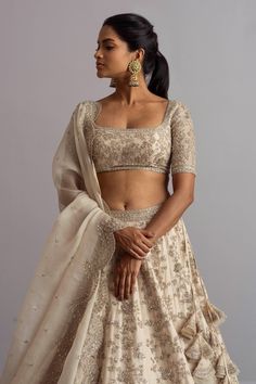 Ivory organza lehenga with cutdana work, floral motifs and scallop hem. Comes with embellished blouse and cutwork border dupatta.
Components:3
Embroidered
Neckline:Square
Sleeve Length:Half
Fabric:Organza
Color:White

Tie-up cutout back
Kamar tassels
Scallop cutwork
Note: Cancan worn by the model is not for sale - Aza Fashions Cutdana Work, Embroidery Square, Organza Embroidery, Anushree Reddy, Organza Lehenga, Embellished Blouse, Embroidered Neckline, White Tie, Scalloped Hem