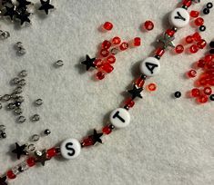 some beads and numbers are laying out on the snow with stars in the sky around them