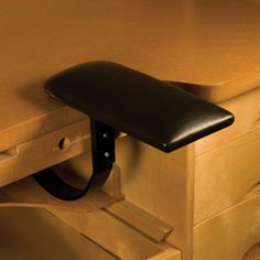 a close up of a drawer with a black handle on it and a wooden cabinet