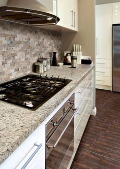 a stove top oven sitting inside of a kitchen