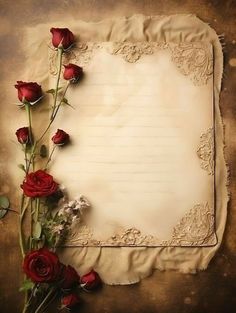 an old paper with red roses on it and a piece of parchment next to it